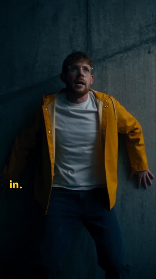 Story episode still: a man in a yellow jacket